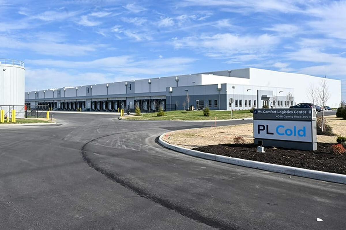 Exterior of PL Cold facility in Greenfield, Indiana showing modern industrial building with multiple loading dock doors and yellow safety railings